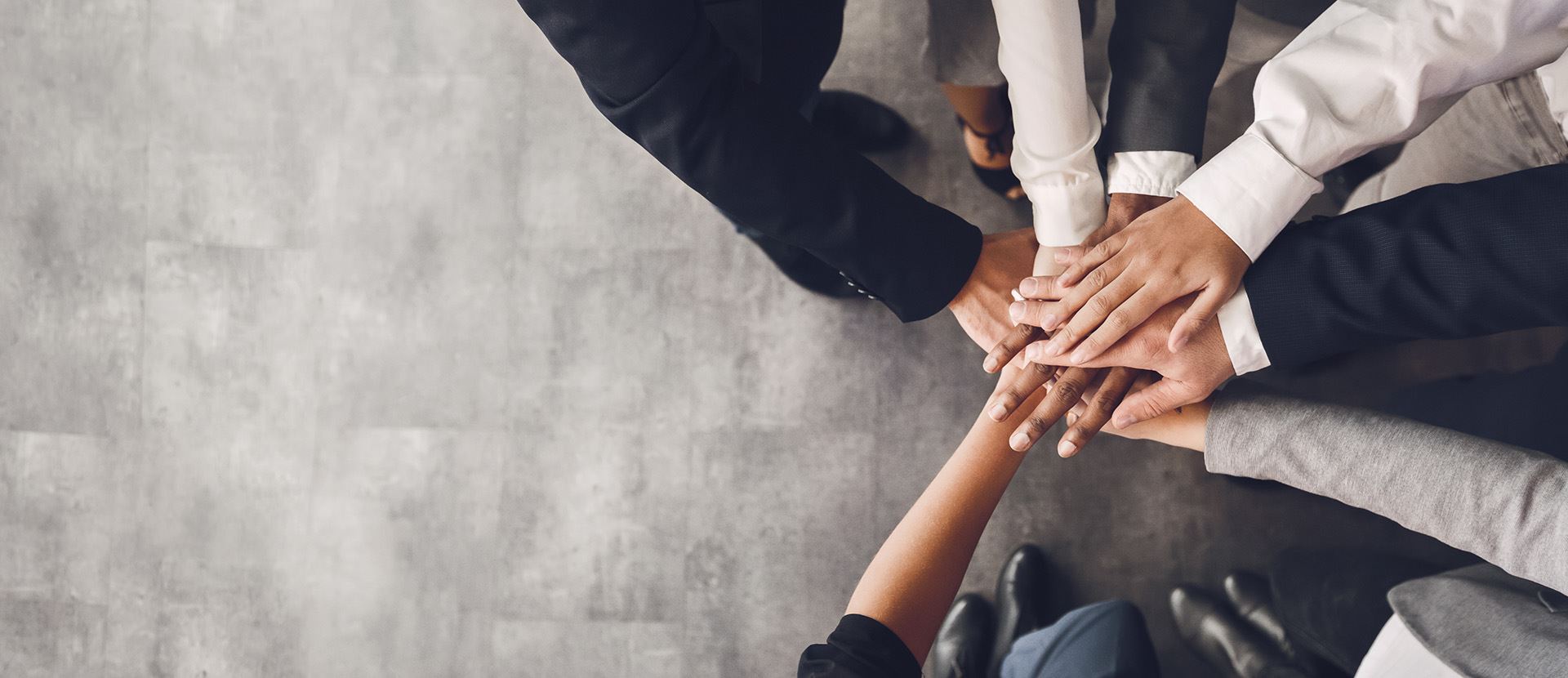 Image of a team putting their hands together