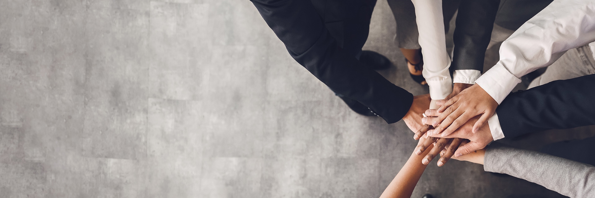 A team of people putting their hands together