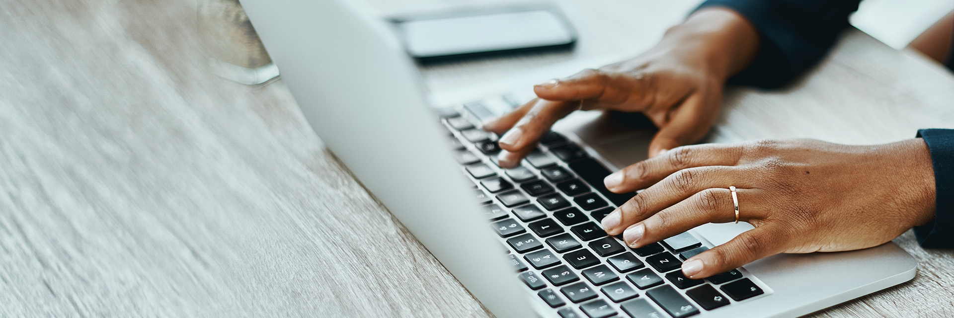 A woman typing on a laptop